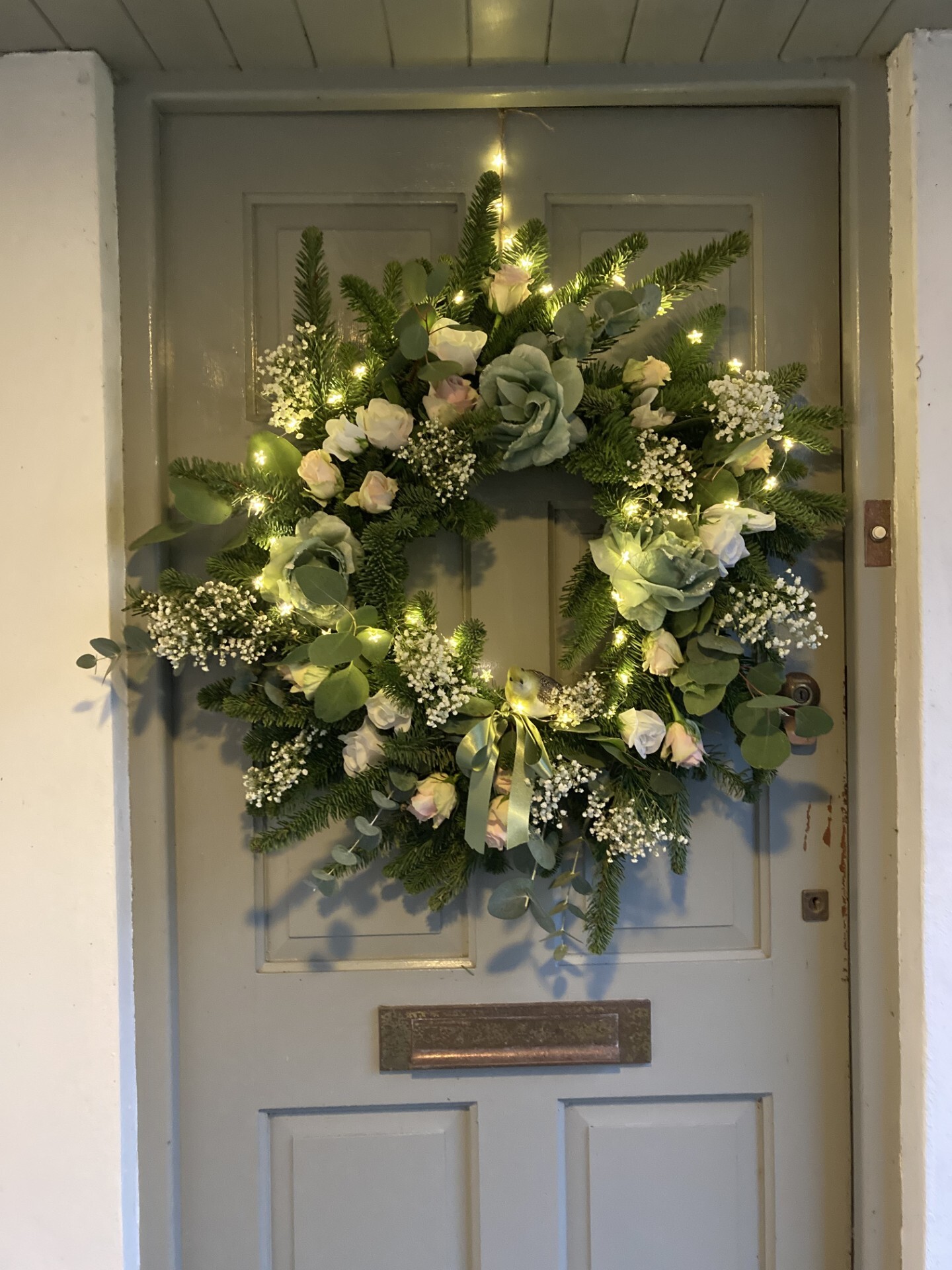 Handmade festive Christmas wreath with greenery and decorations for a charity Christmas wreath making workshop